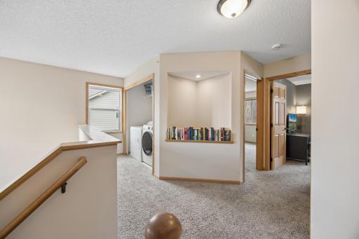 Spacious upper level landing with laundry, lighted art nook, and tons of natural light