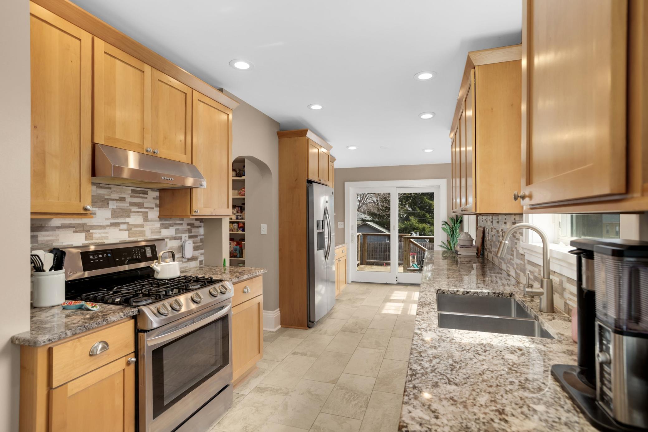 Large open kitchen with door out to the back.