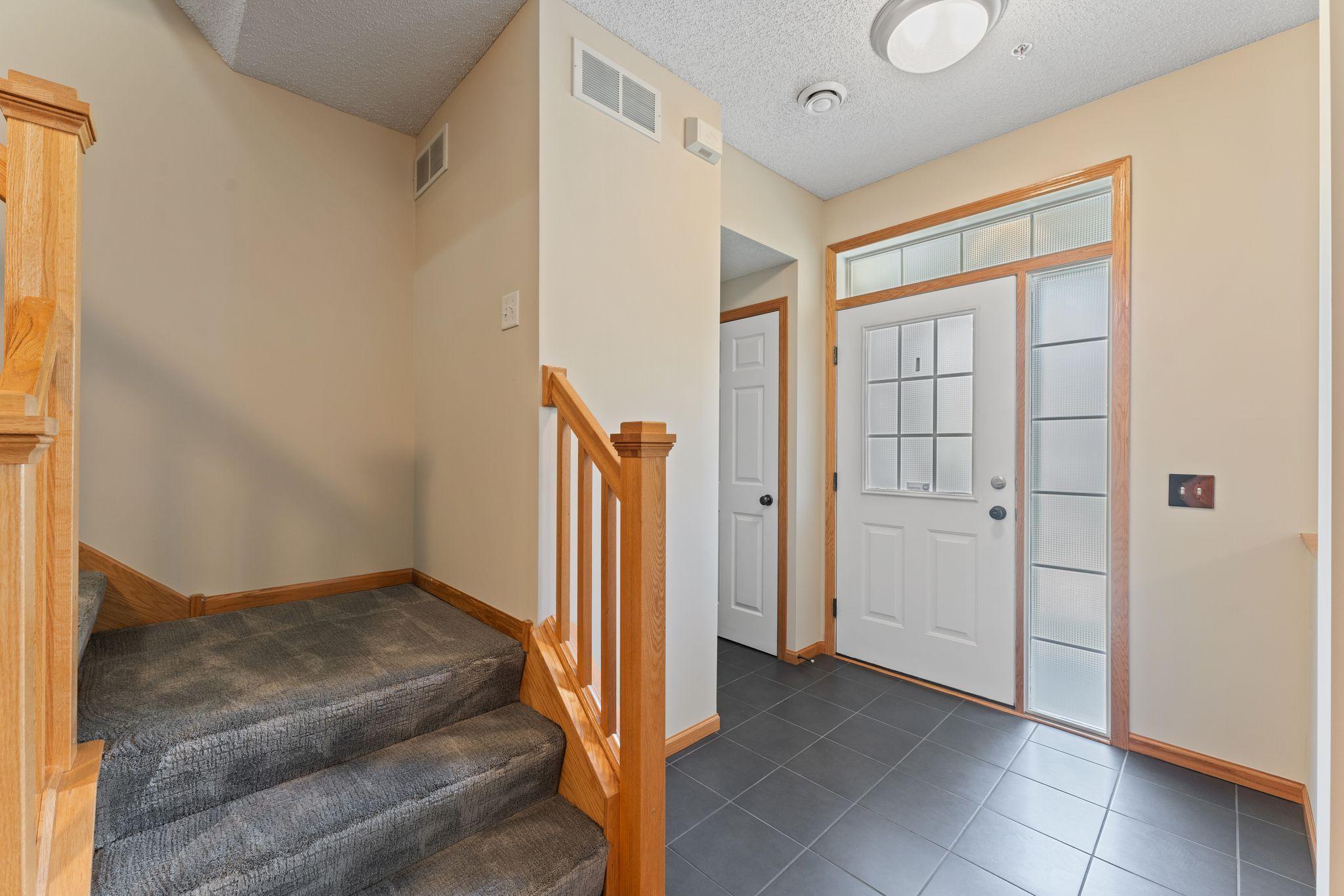 Large Tiled Entryway with Coat Closet