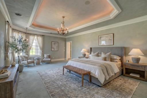 Upstairs, the primary suite is a private sanctuary, featuring a spa-inspired bath with heated marble floors, a soaking tub, a walk-in shower, and a custom-designed wardrobe room. (virtually staged)