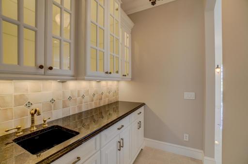 A fully appointed butlerâs pantry and separate walk-in pantry support effortless hosting.