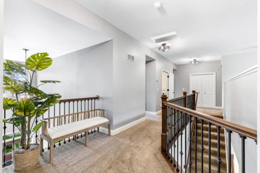 Spacious hallway separating the primary from the other three bedrooms