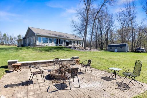 Large firepit area overlooks the water and is shared with the neighbor.