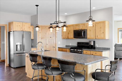 Kitchen includes a large center island and walk-in pantry.
