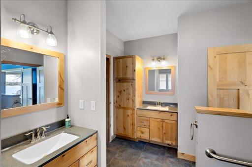 Spacious owner's bathroom with dual sinks, tiled floors, jetted tub and walk-in shower.