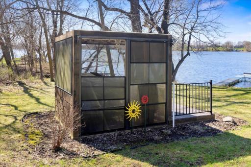 Small screened enclosure by the water's edge. Enjoy water views mosquito free! ha