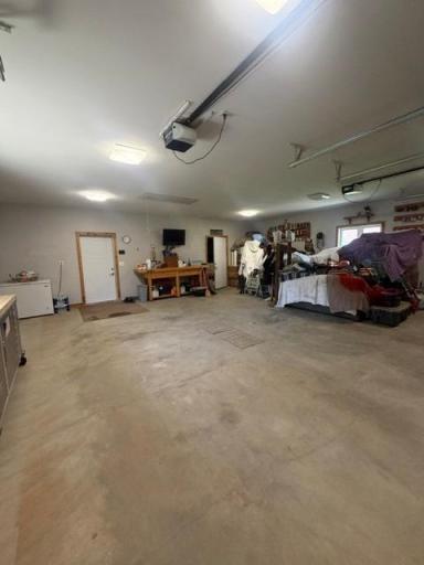 This massive in floor heated 3 car garage (29'x27') can accommodate all your lake toy management!