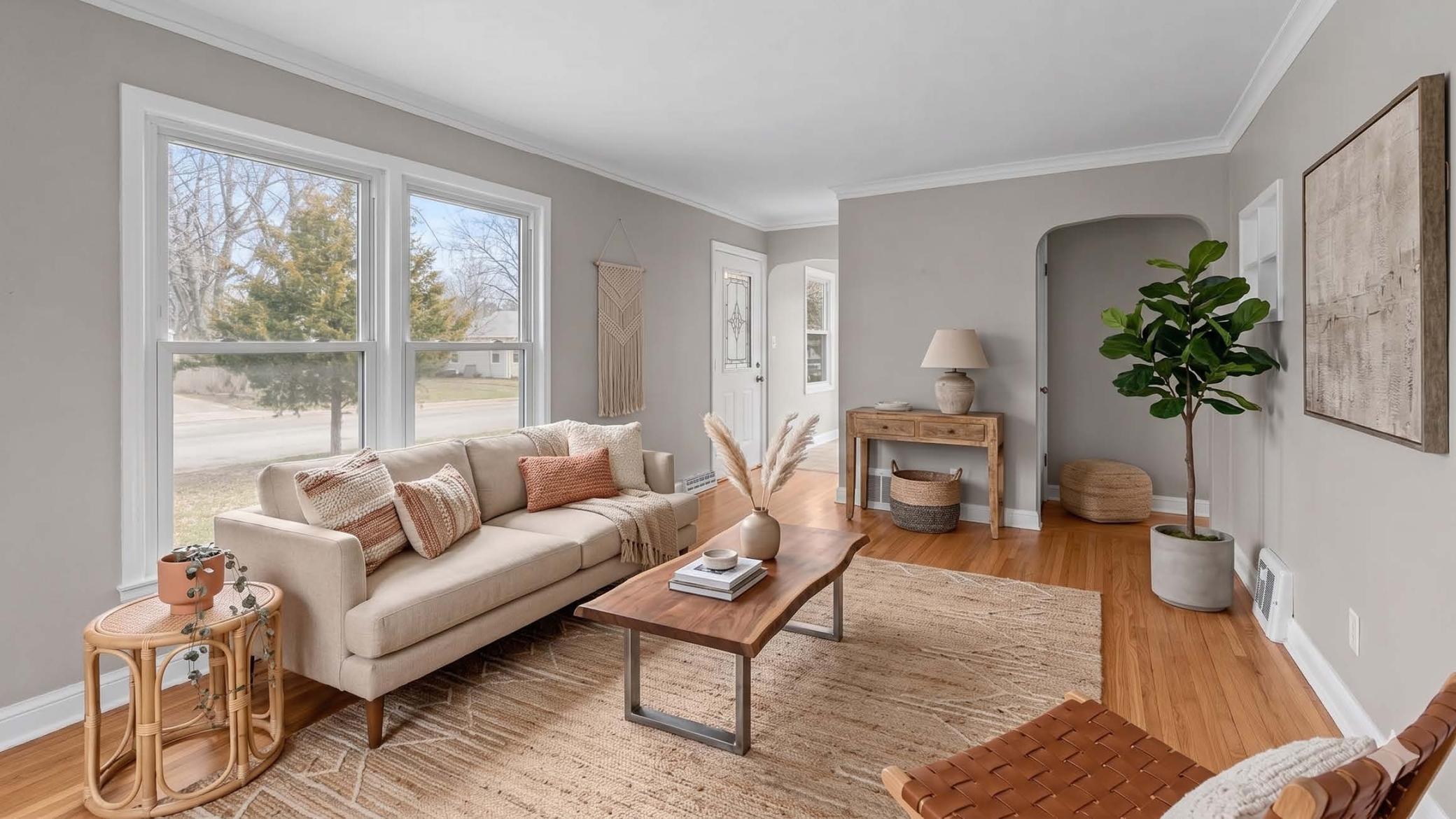 Large front window brings in a ton of natural light. Gorgeous hardwood flooring! (virtually staged)