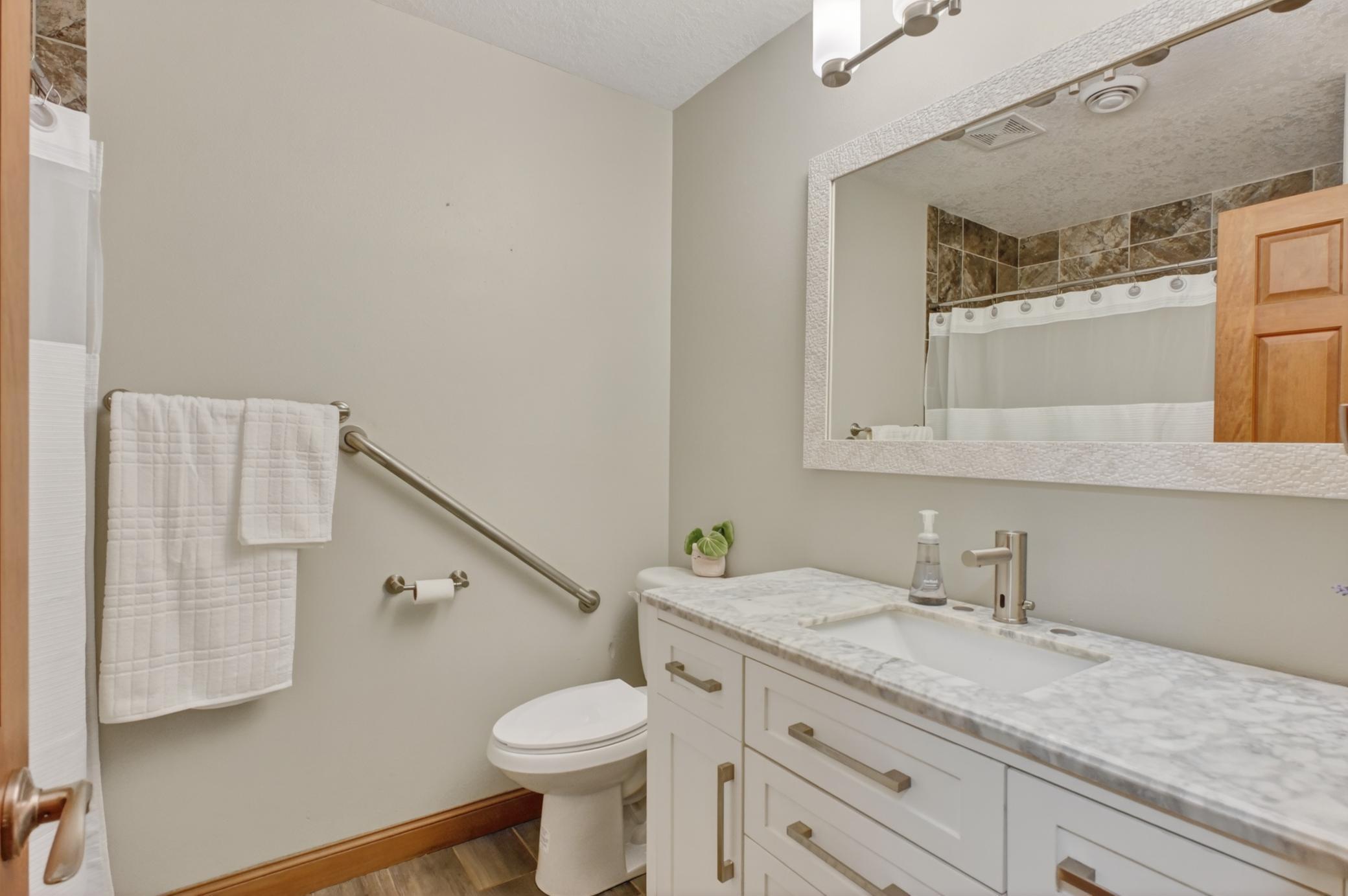 Upper full bath, tile floors and around tub