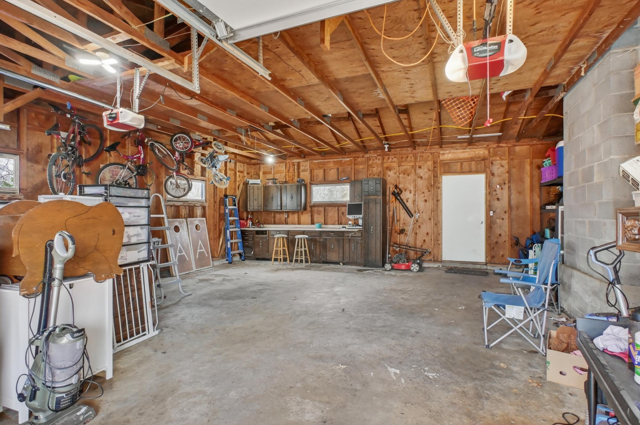 Large garage with workbench and storage