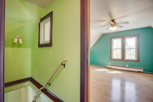 Stairs looking into third story bedroom