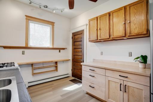 Kitchen with door to back stairs going to second level