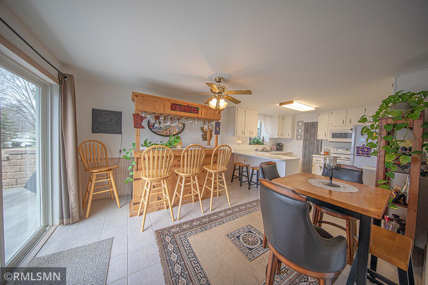 The dining area is flooded with natural light and opens to your outdoor patio for grilling.