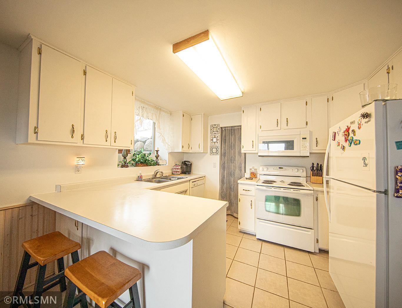 Cabinets galore and seating at the island for conversing with the cook!