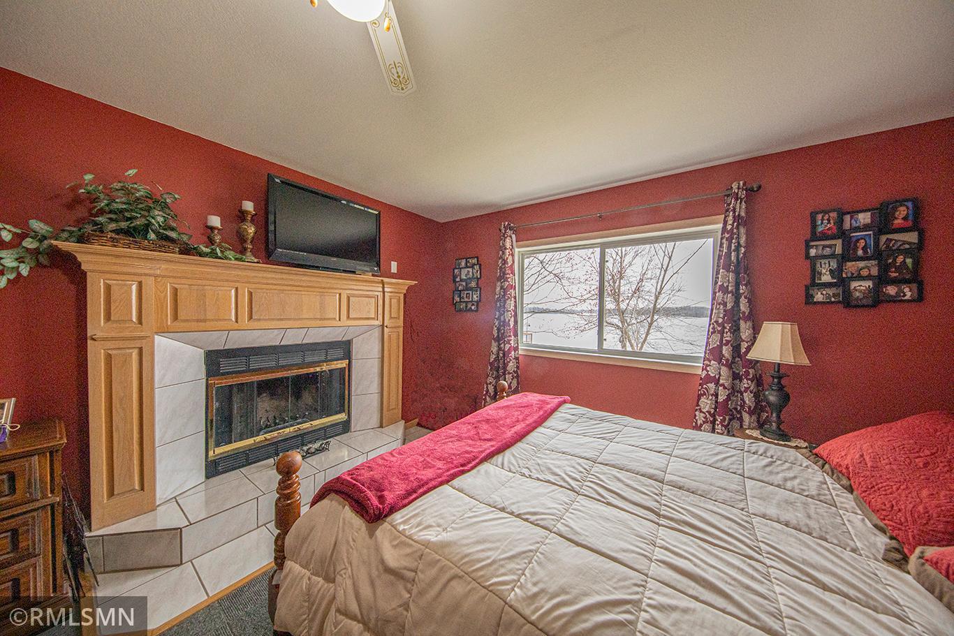 The primary bedroom has an expansive view of West Rush Lake to wake up to every morning.