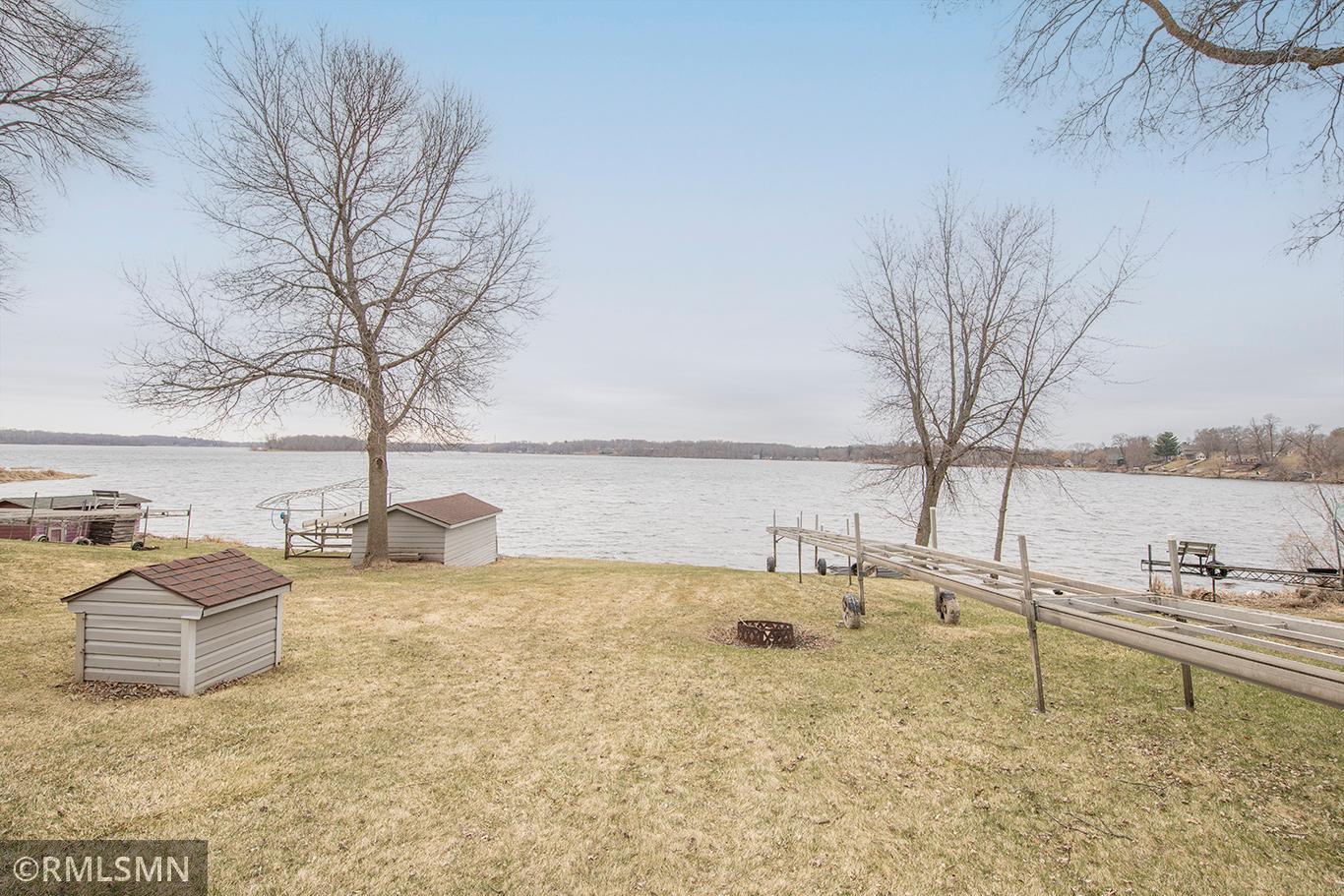 A boathouse on the shore, the well house in the yard and a gentle slope to the lake.