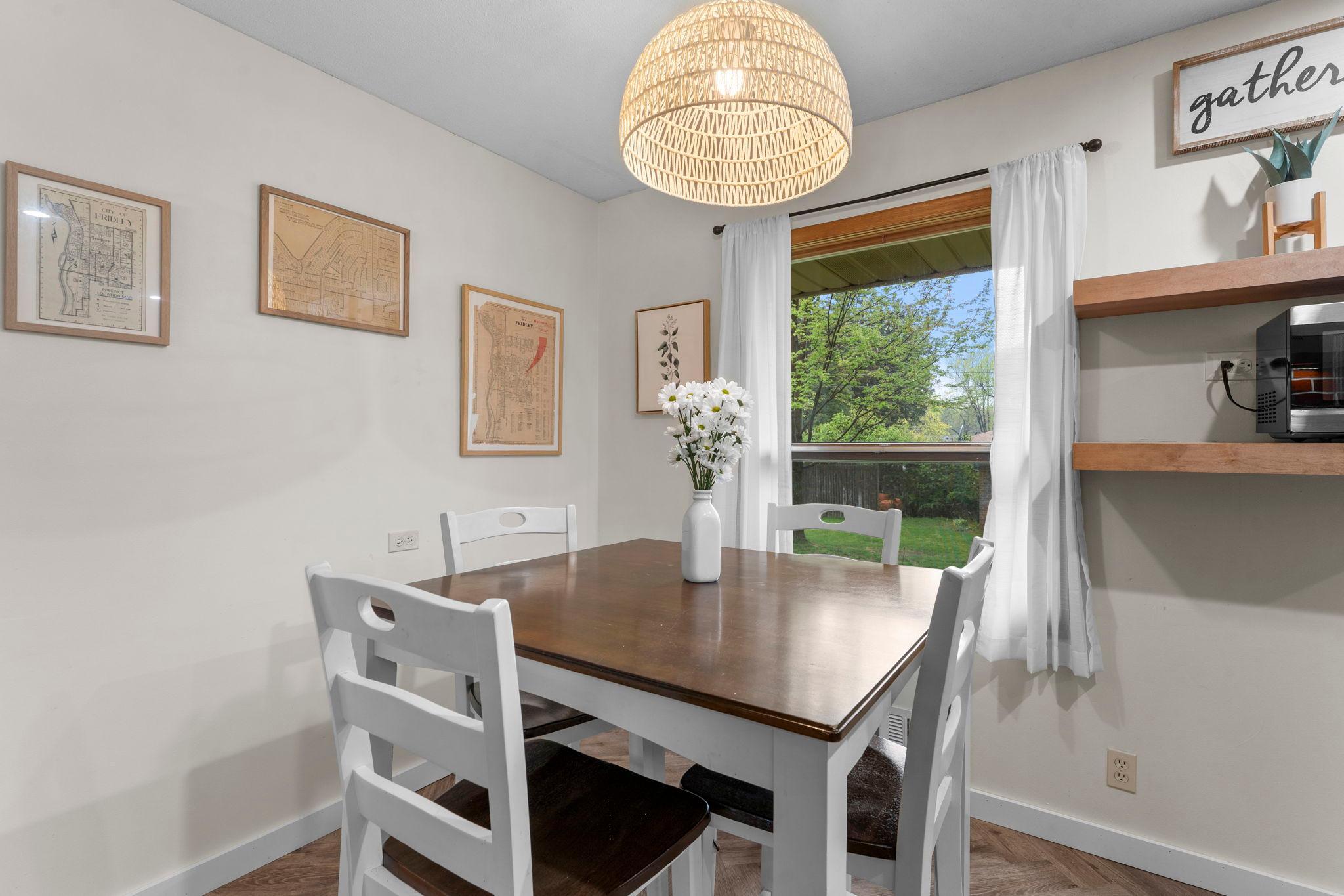 It flows seamlessly into the dining area, highlighted by statement lighting for an elevated touch.