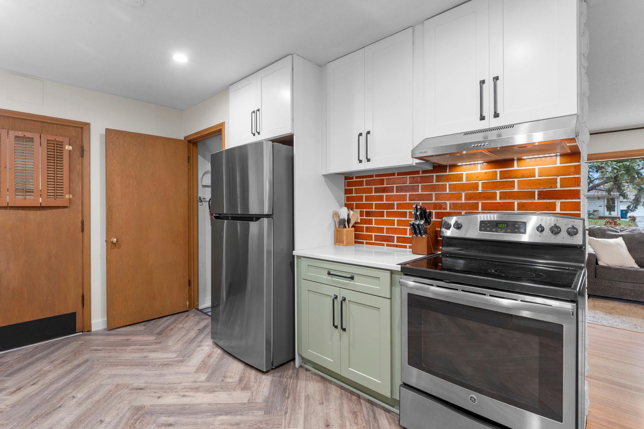 The updated kitchen (2022) continues the story with stainless steel appliances and two-tone cabinetry.
