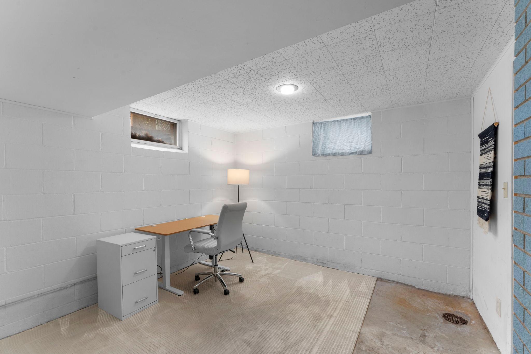 There’s additional flex space perfect for a future bedroom or office. This room also the beautiful blue brick wall.