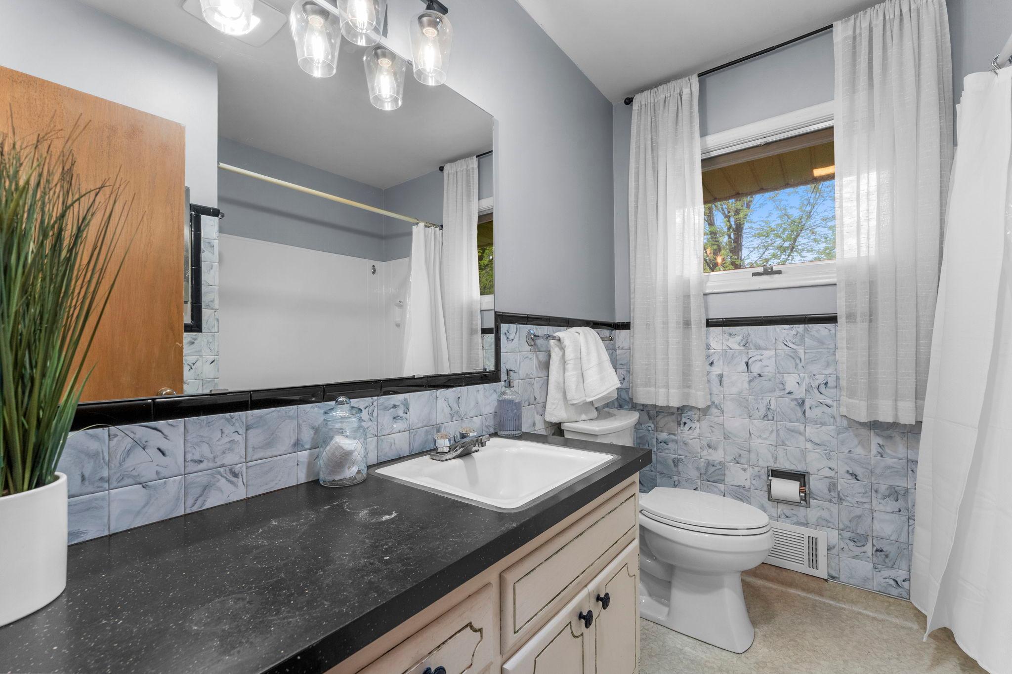 The nearby full bathroom offers a tub/shower combination, extended vanity for added function.