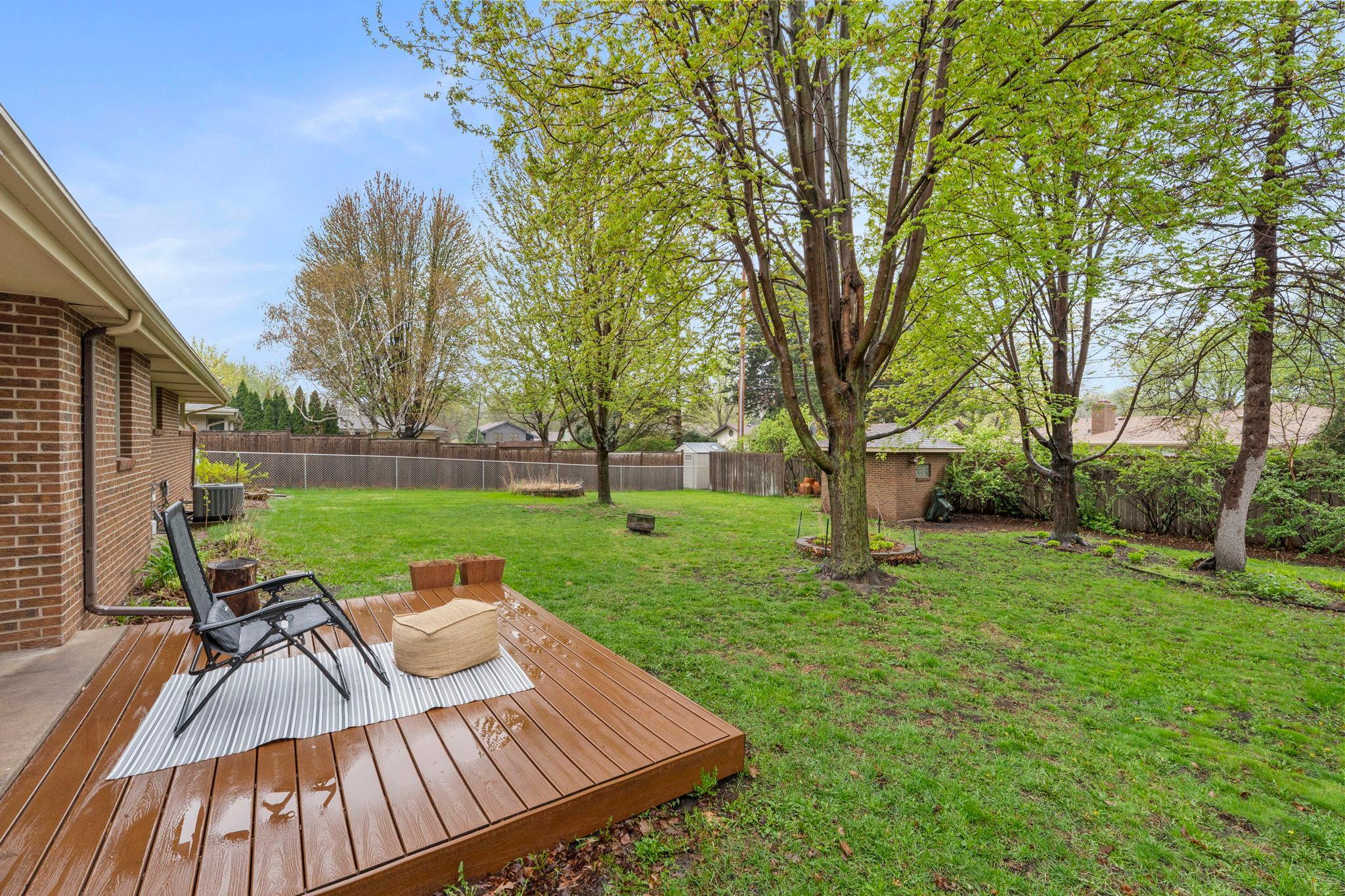 A covered porch connects to maintenance-free decking, creating a seamless and spacious outdoor living area ideal for relaxing or entertaining.