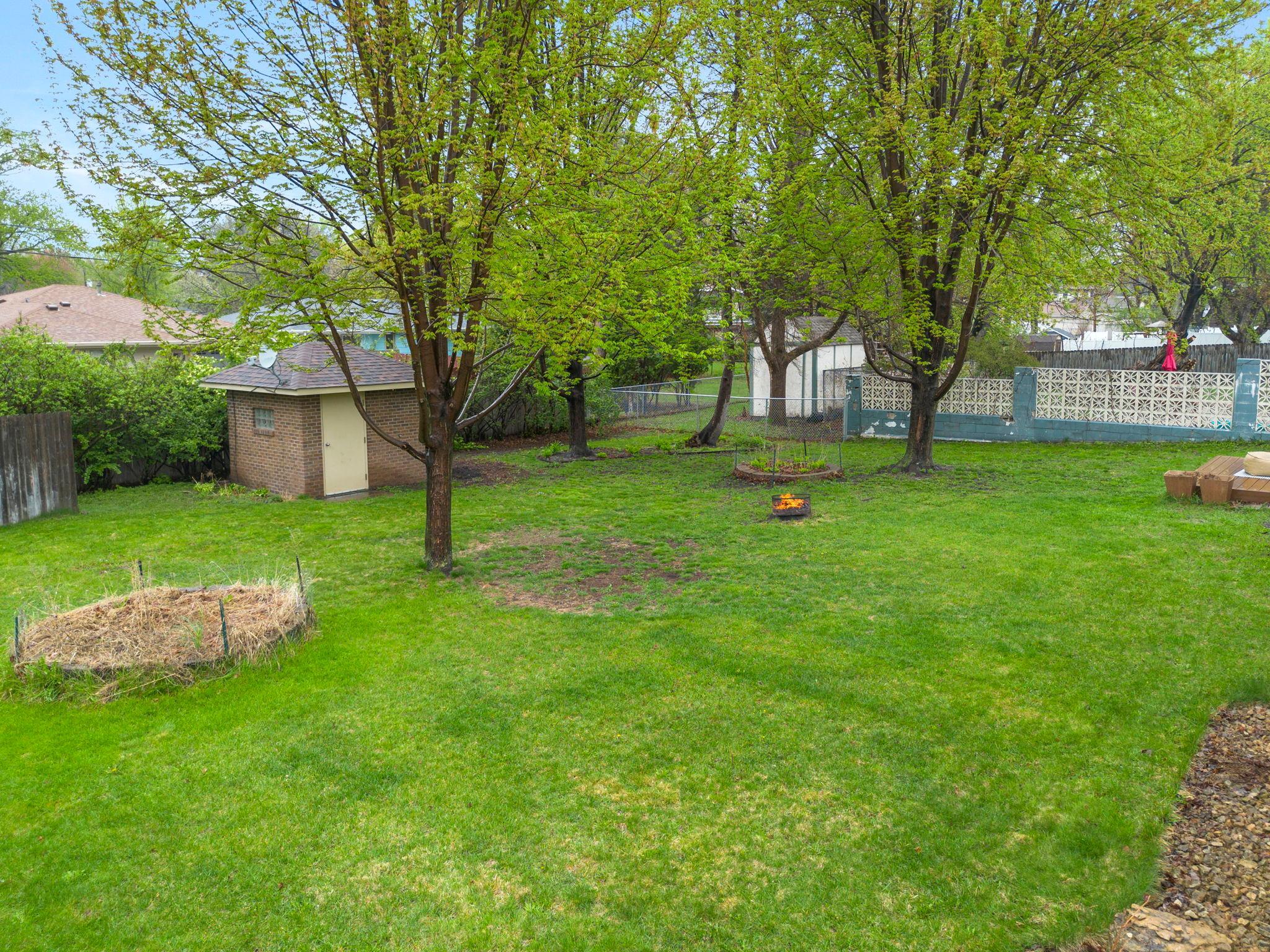 Mature trees, thoughtful landscaping, and a storage shed complete the setting. New furnace (2023), water heater (2025), spray foam insulation (2025), and new garage door (2025).