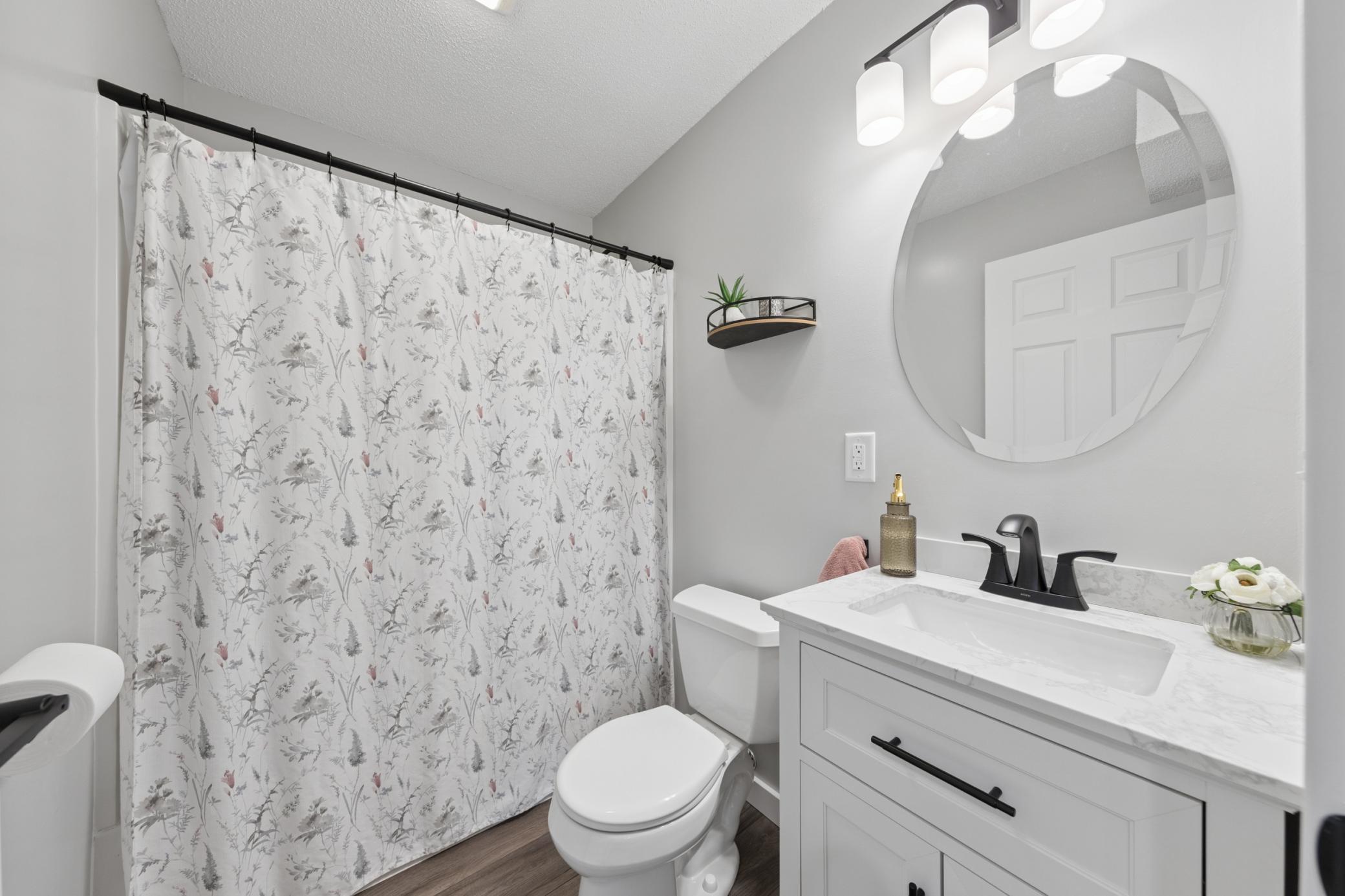 The lower level full bathroom features, new paint and a new vanity.