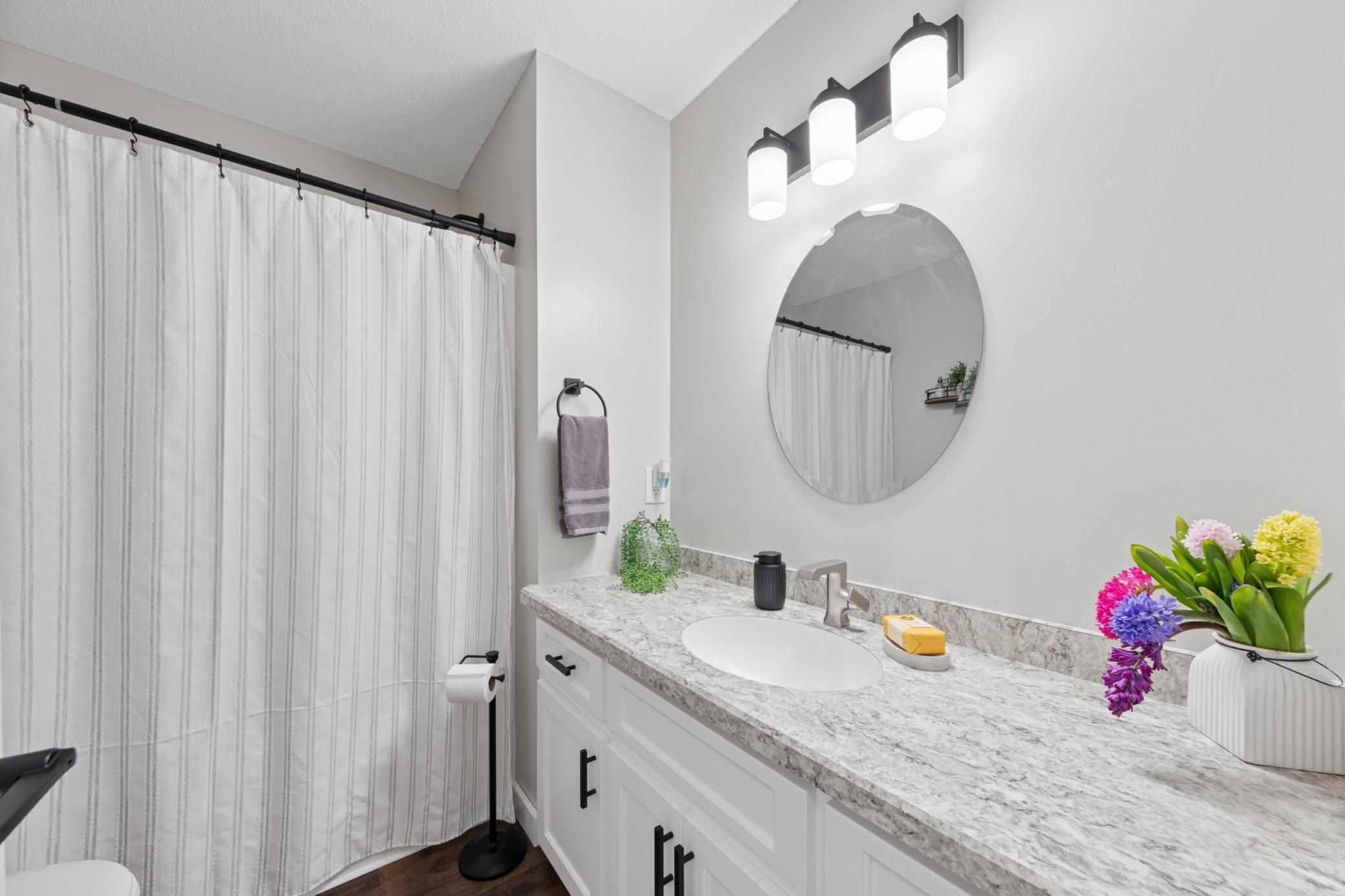 The large main level full bathroom features extra counter space.jpg