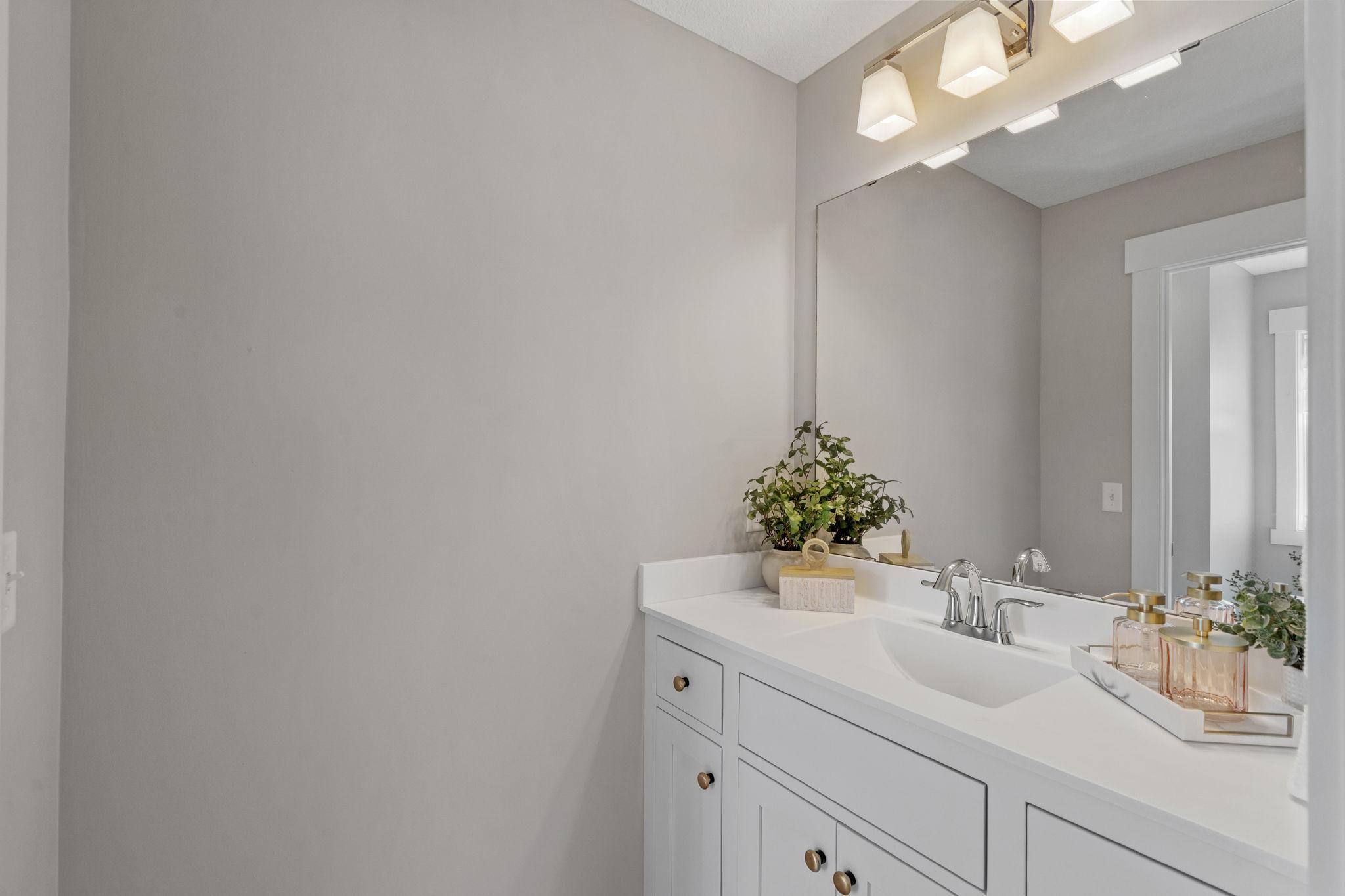 Bedrooms #3 and #4 are connected by a smartly laid-out bathroom with separate, dual vanities and a private shared shower/toilet room.