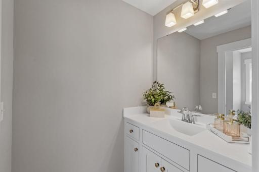 Bedrooms #3 and #4 are connected by a smartly laid-out bathroom with separate, dual vanities and a private shared shower/toilet room.