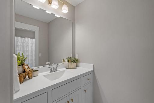 Jack-and-Jill style bathroom connecting bedrooms #3 and #4, featuring separate vanities.