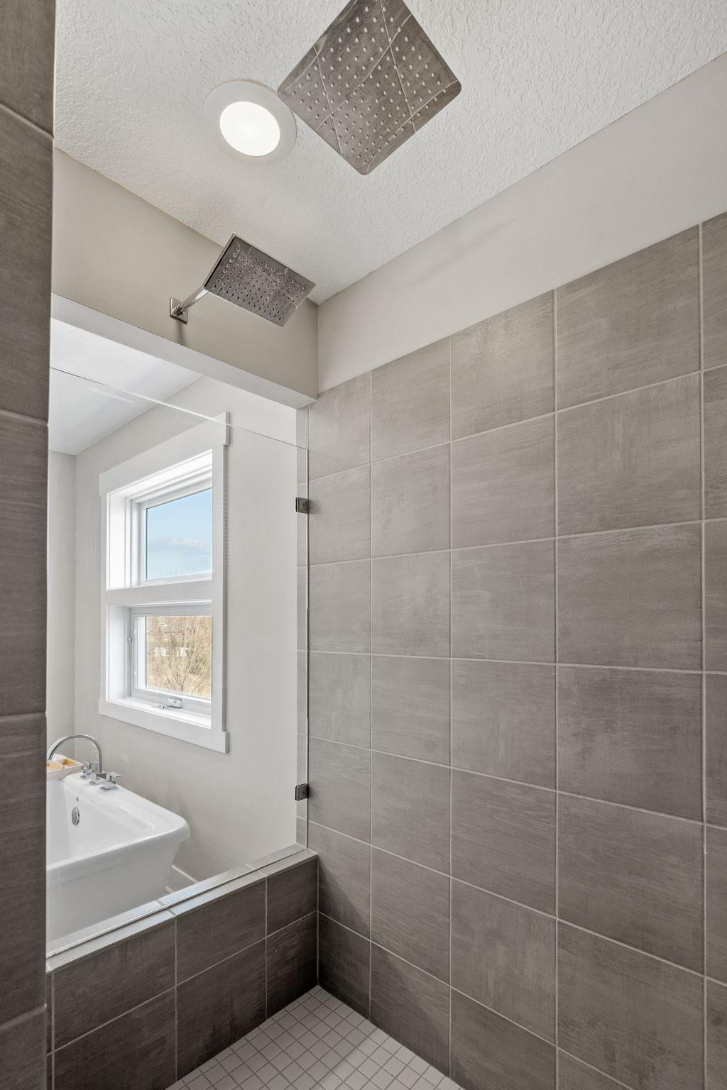 Expansive tiled walk-in shower with modern finishes and plenty of space for a true luxury feel.