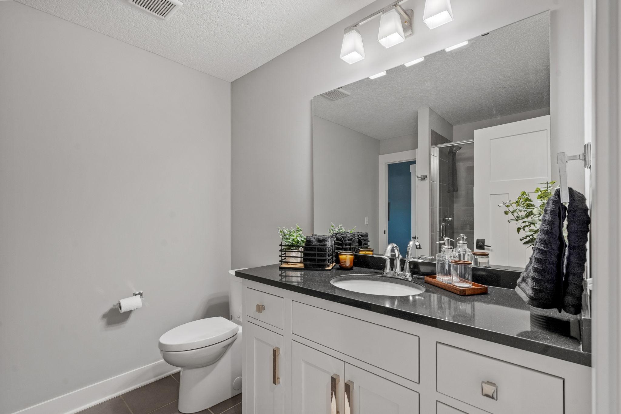 Bedroom #2 enjoys its own adjoining bath with contemporary finishes and a functional, well-designed layout.