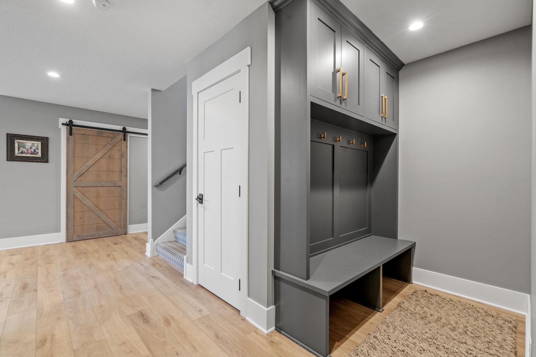 Lower level custom built-ins give you the perfect place to organize everything from sport court gear to workout equipment to skates for the pond.