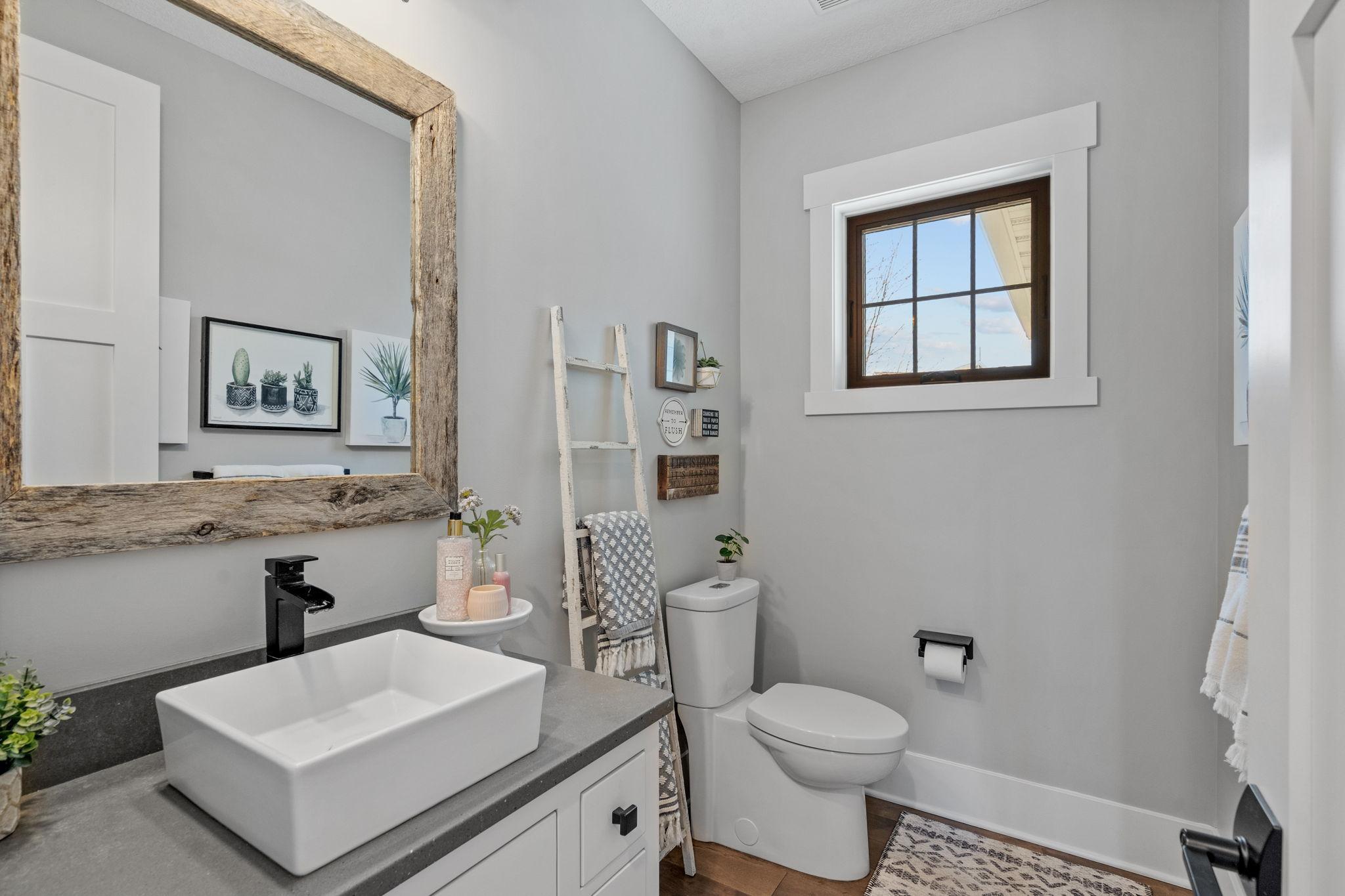A well-appointed main floor half bath offers convenience for guests while maintaining the home’s cohesive, elevated design.