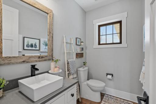 A well-appointed main floor half bath offers convenience for guests while maintaining the homeâs cohesive, elevated design.