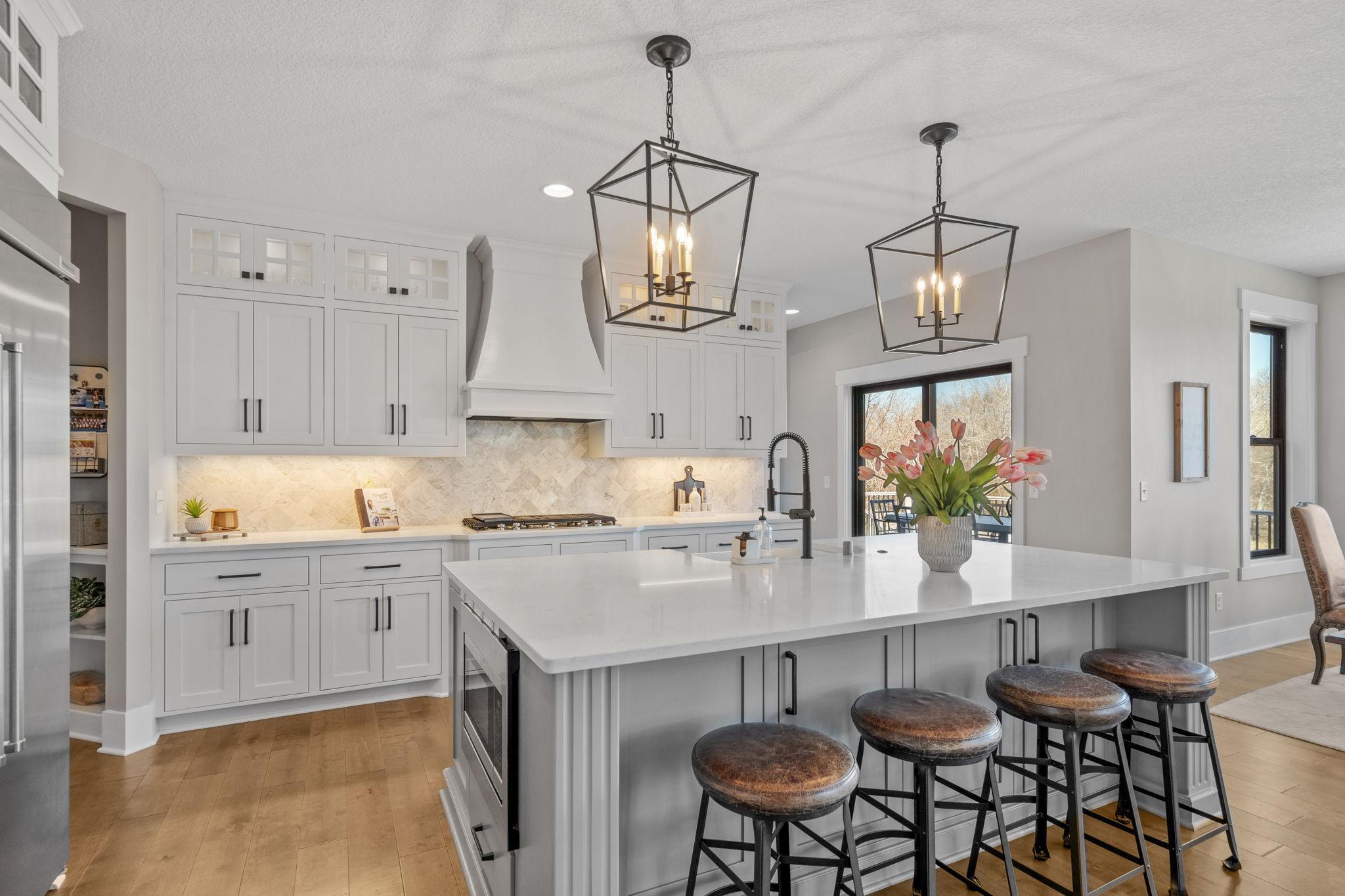 Expansive center island offers generous storage, complemented by abundant cabinetry designed to keep everything organized and within reach.