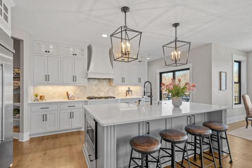 Expansive center island offers generous storage, complemented by abundant cabinetry designed to keep everything organized and within reach.
