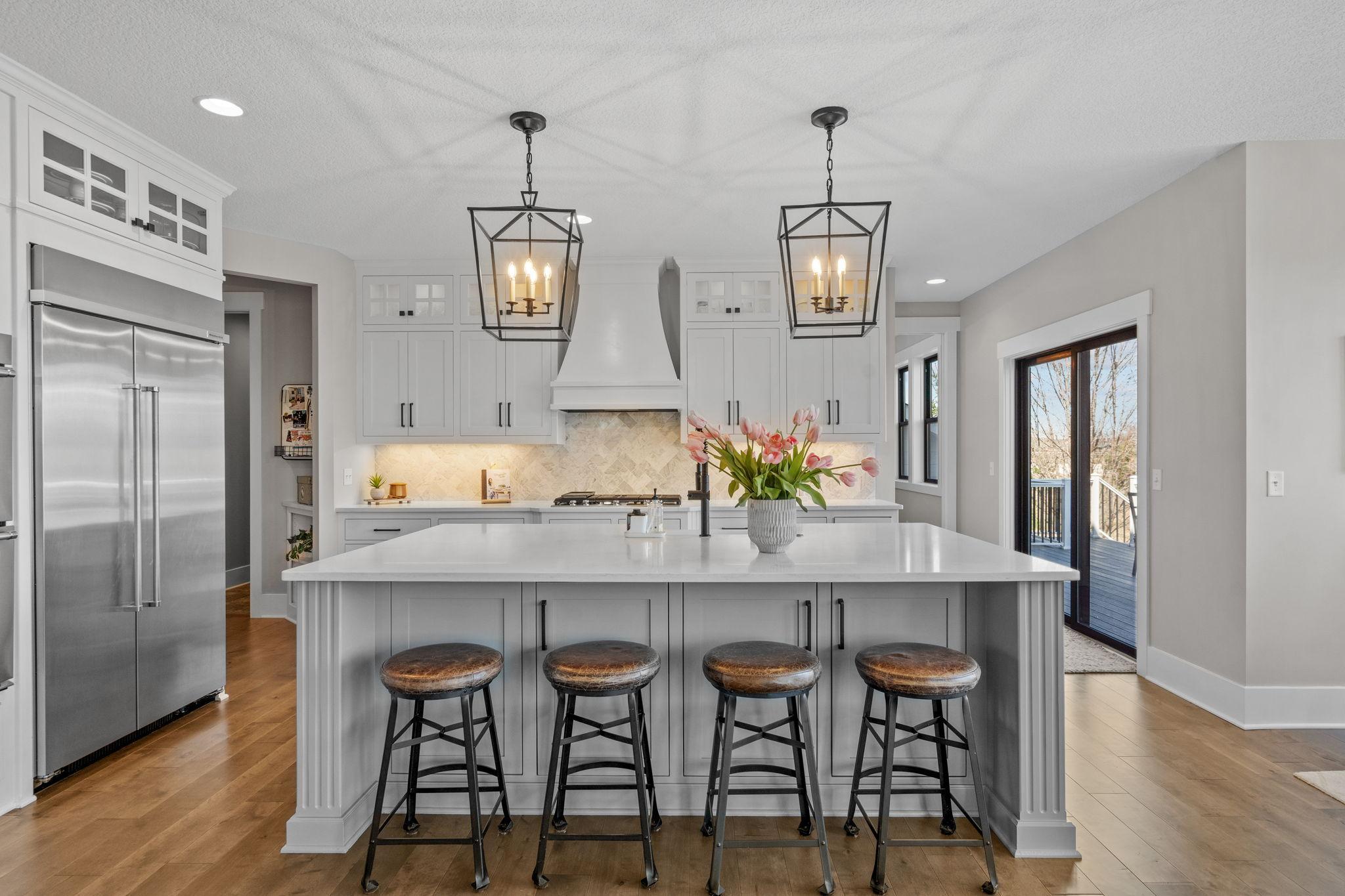 Expansive center island with seating for four, perfect for gathering and entertaining.
