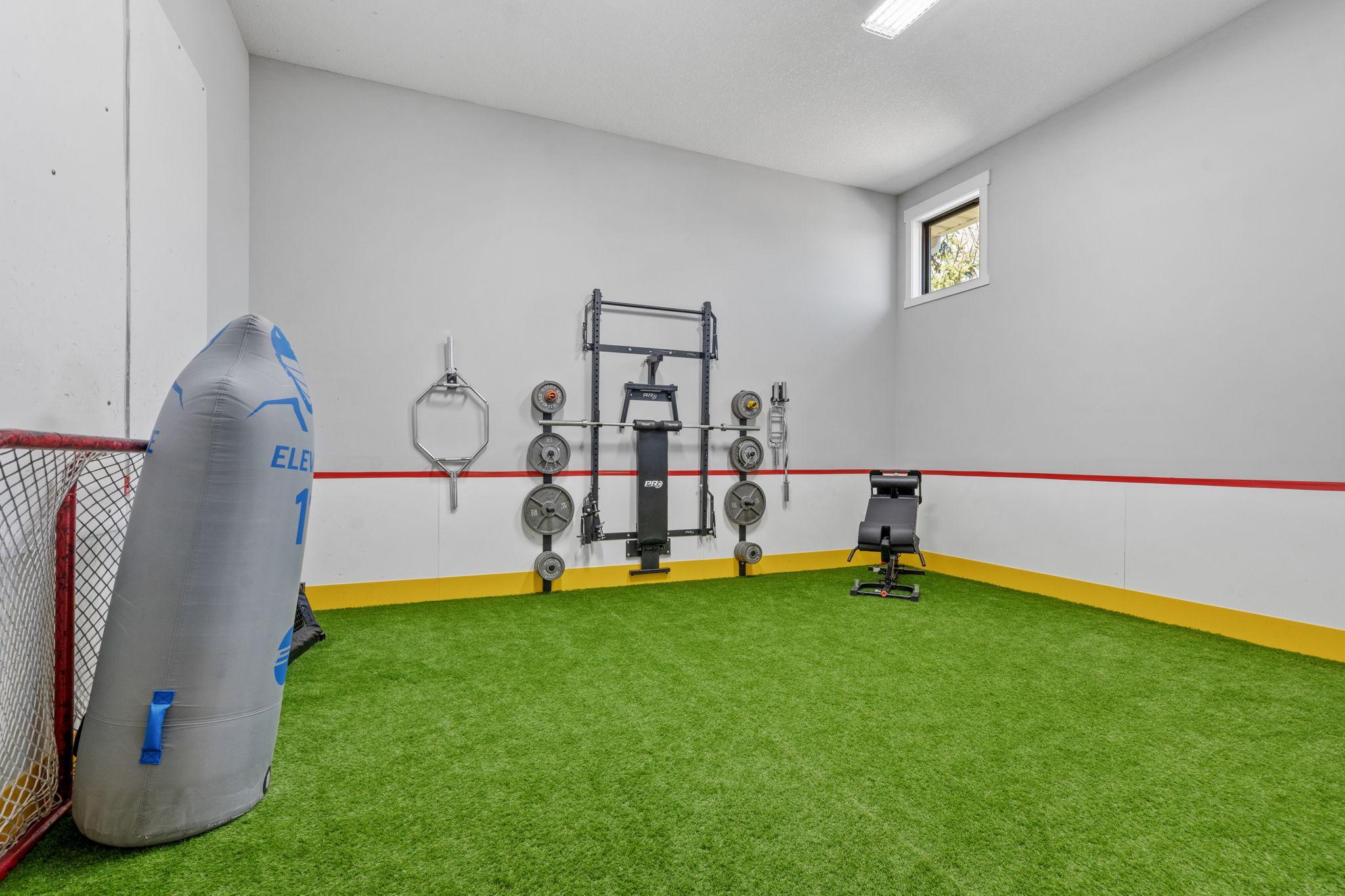 Next-level home setup with your own sport court that includes turf flooring, high ceilings, and plenty of room to train, practice, and play without ever leaving home.