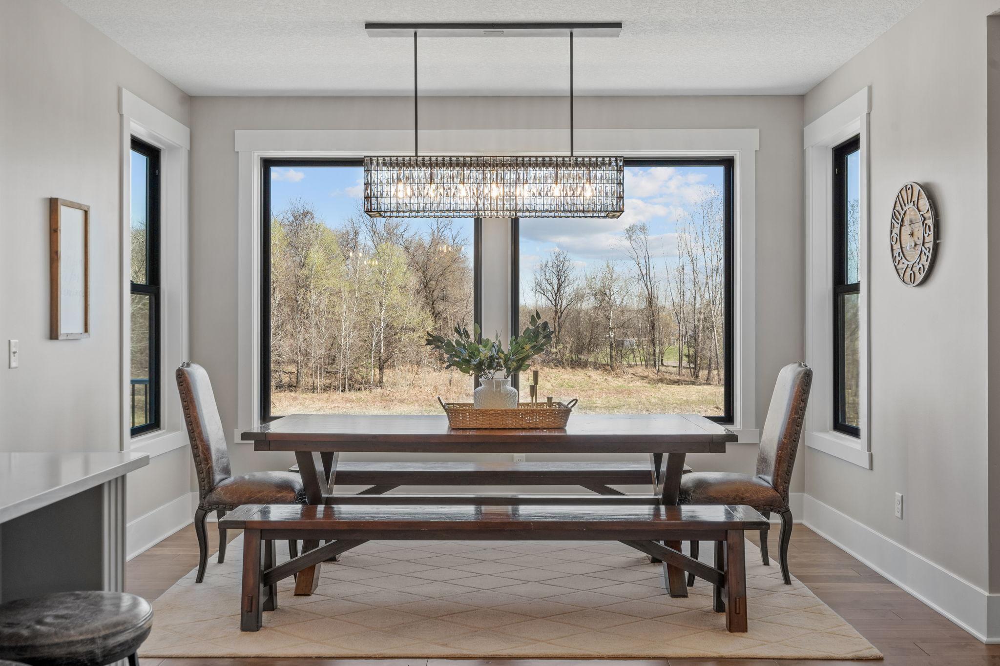Walls of windows bring in natural light and showcase peaceful backyard views.