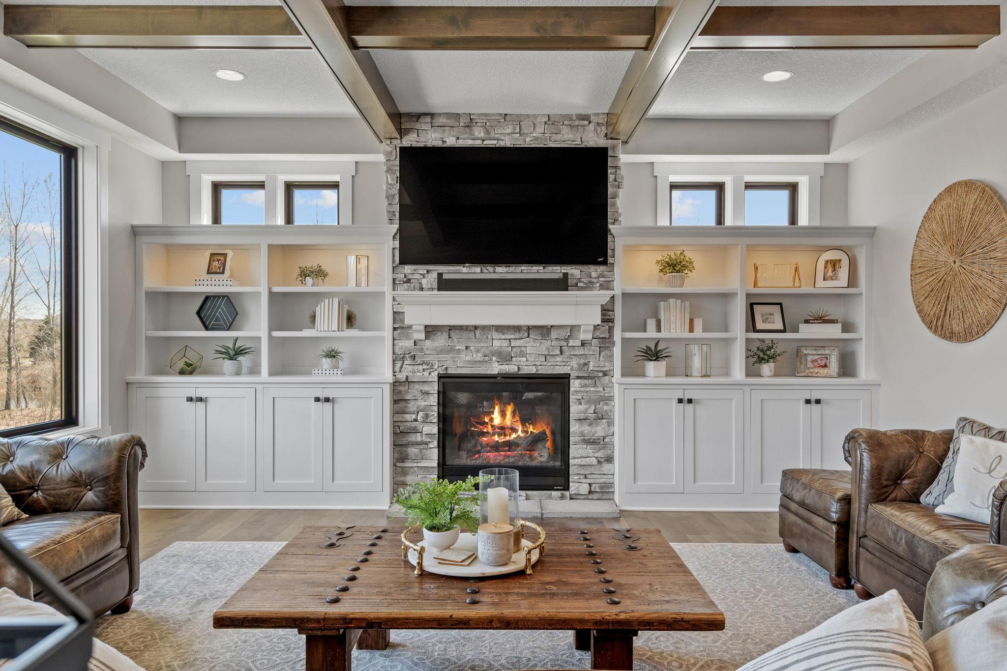 Floor-to-ceiling stone fireplace creates a stunning focal point and cozy gathering space.