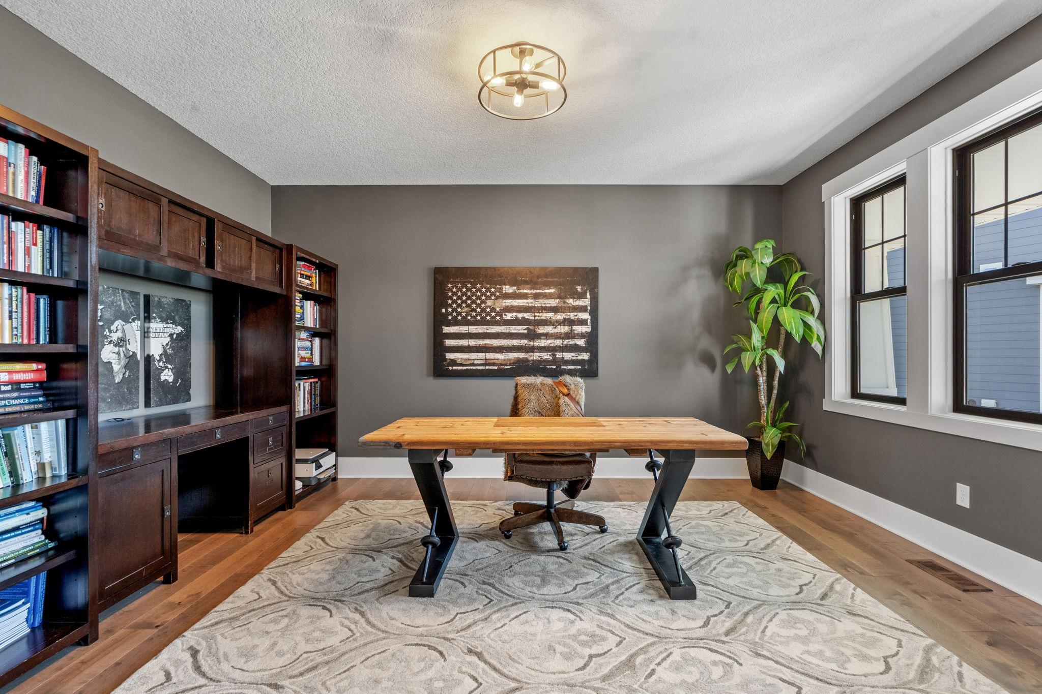 The primary main floor office offers a private, polished workspace ideal for focused productivity.