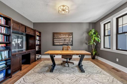 The primary main floor office offers a private, polished workspace ideal for focused productivity.