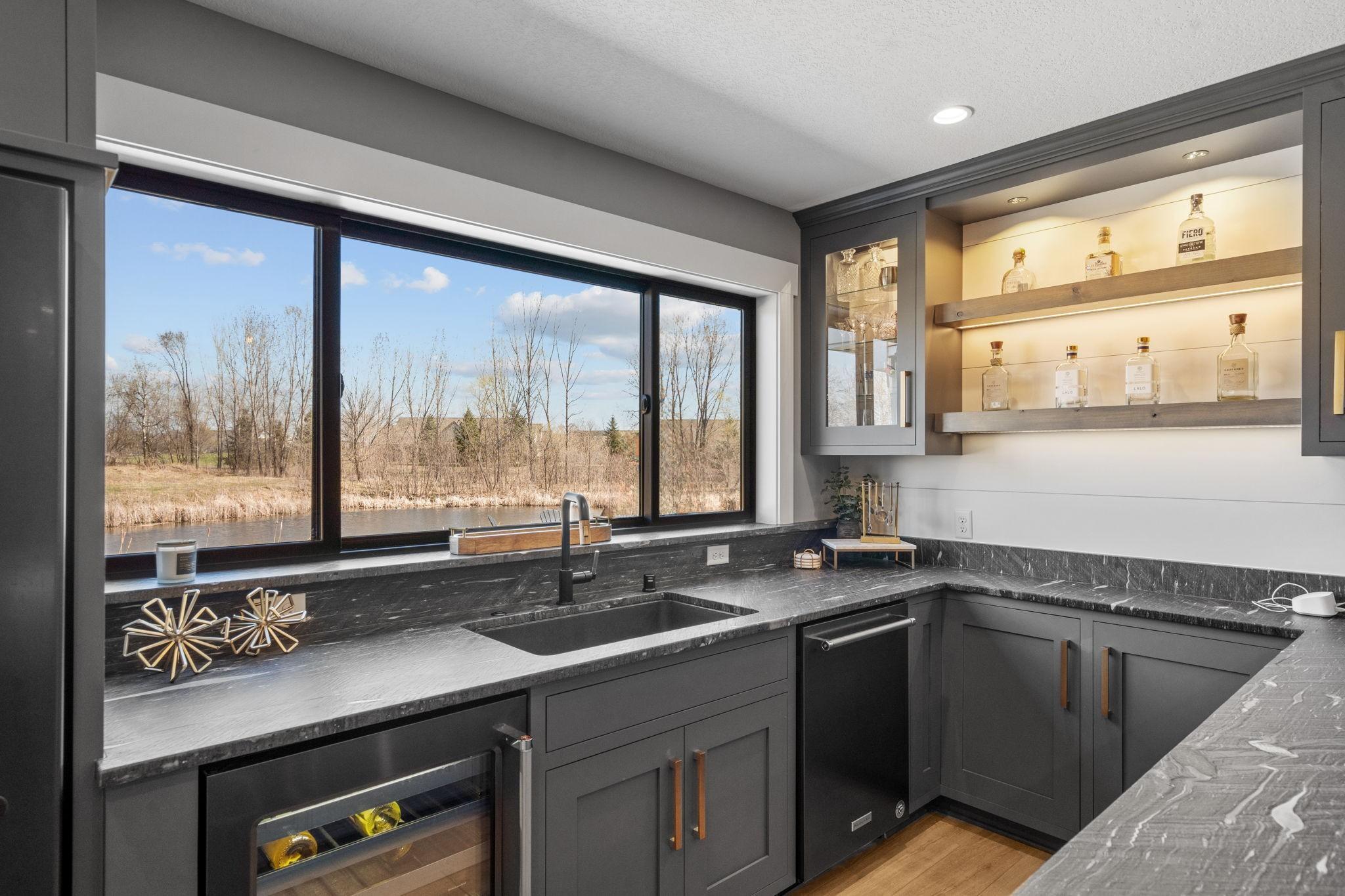 Your own lower level bar with a view. Mix a drink while overlooking the pond and enjoy a space that feels anything but below ground.