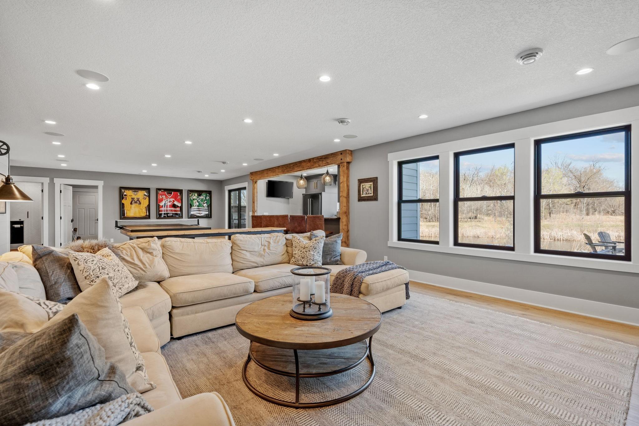 Not your typical basement feel. Large windows bring in incredible natural light, making this family room feel bright, open, and inviting.
