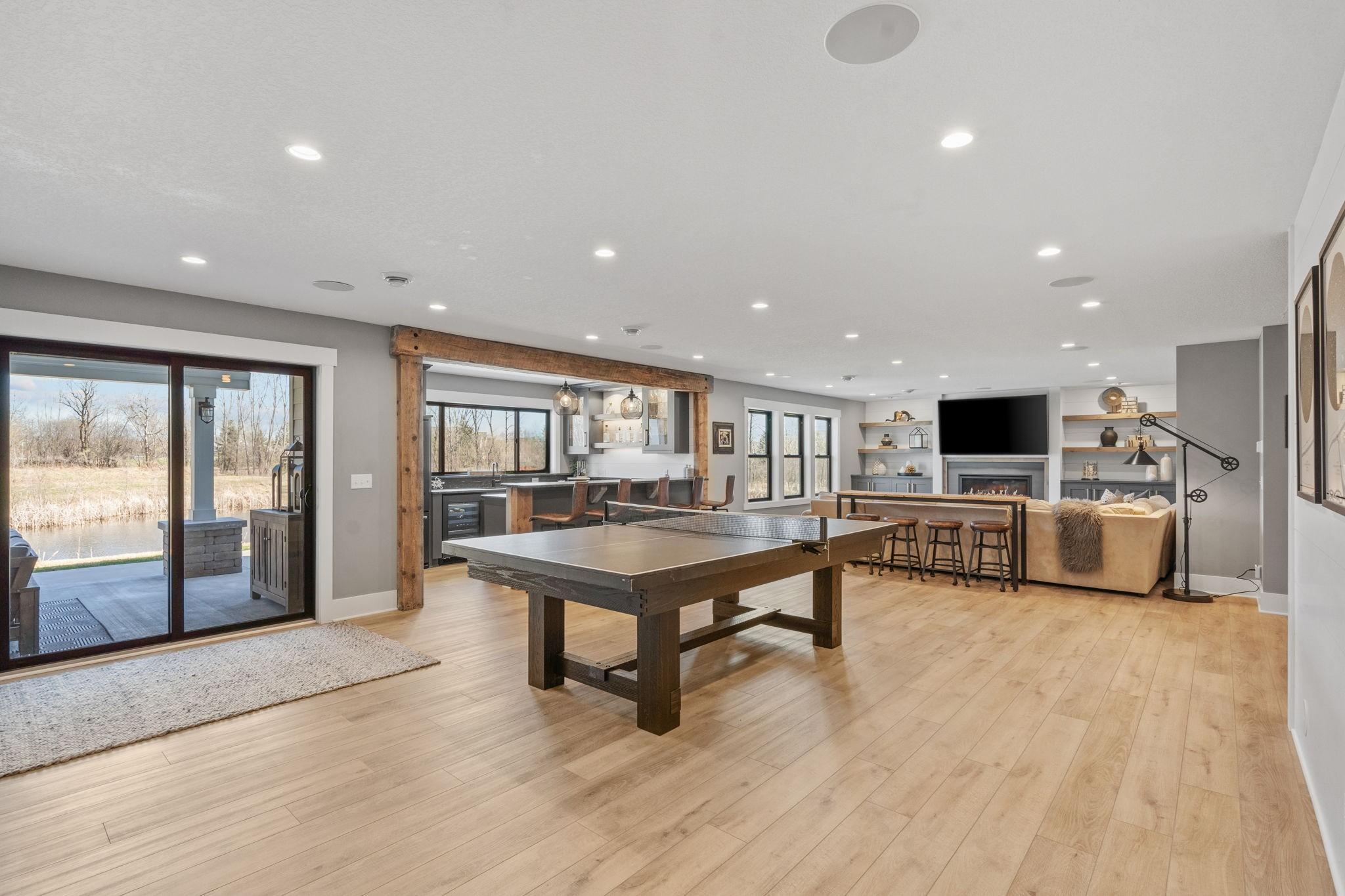 This lower level was made for gathering. Spacious family room, cozy fireplace, and a full game area that keeps everyone entertained.