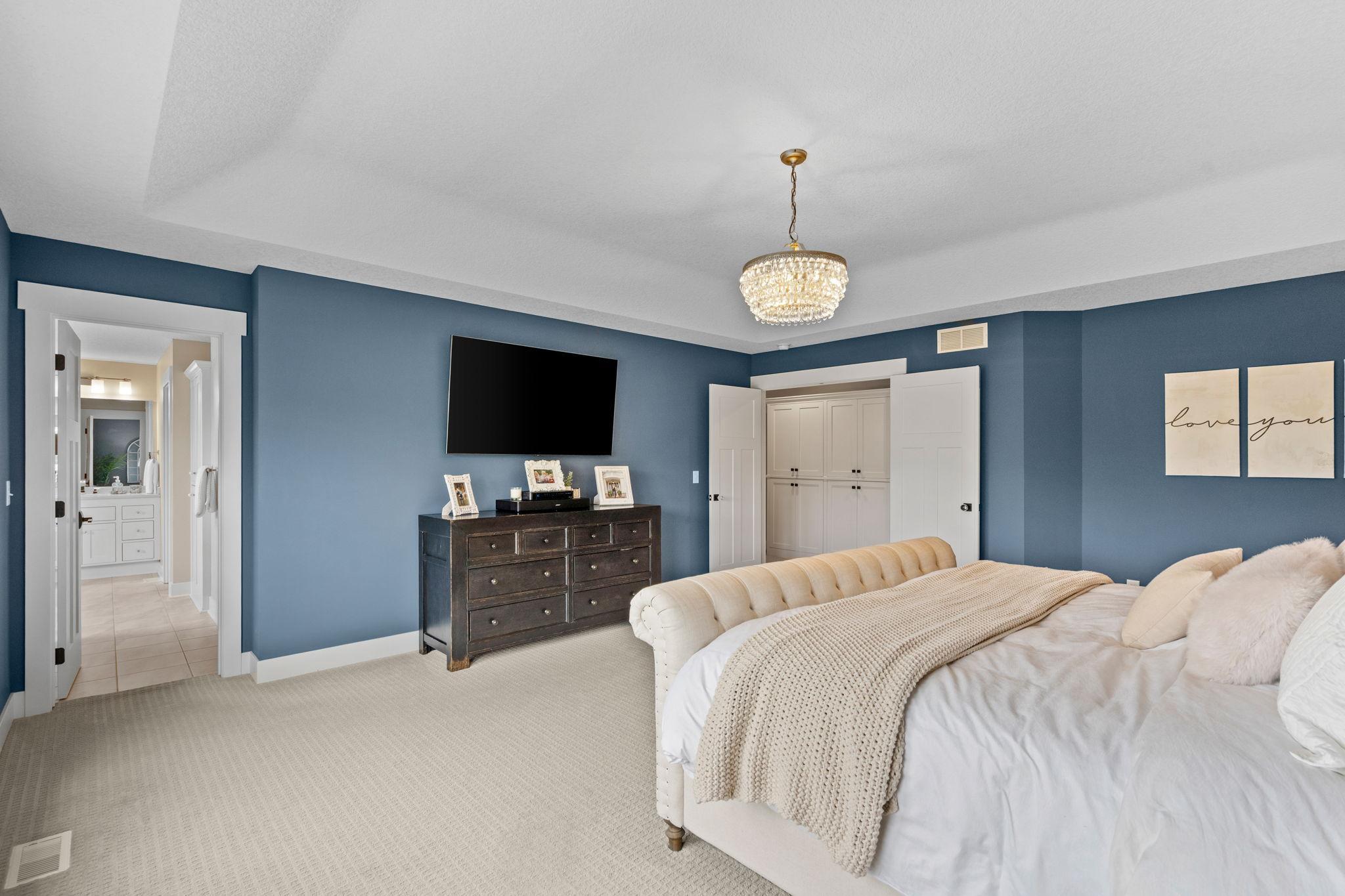 Double doors and seamless access to the ensuite bath and walk-in closets.