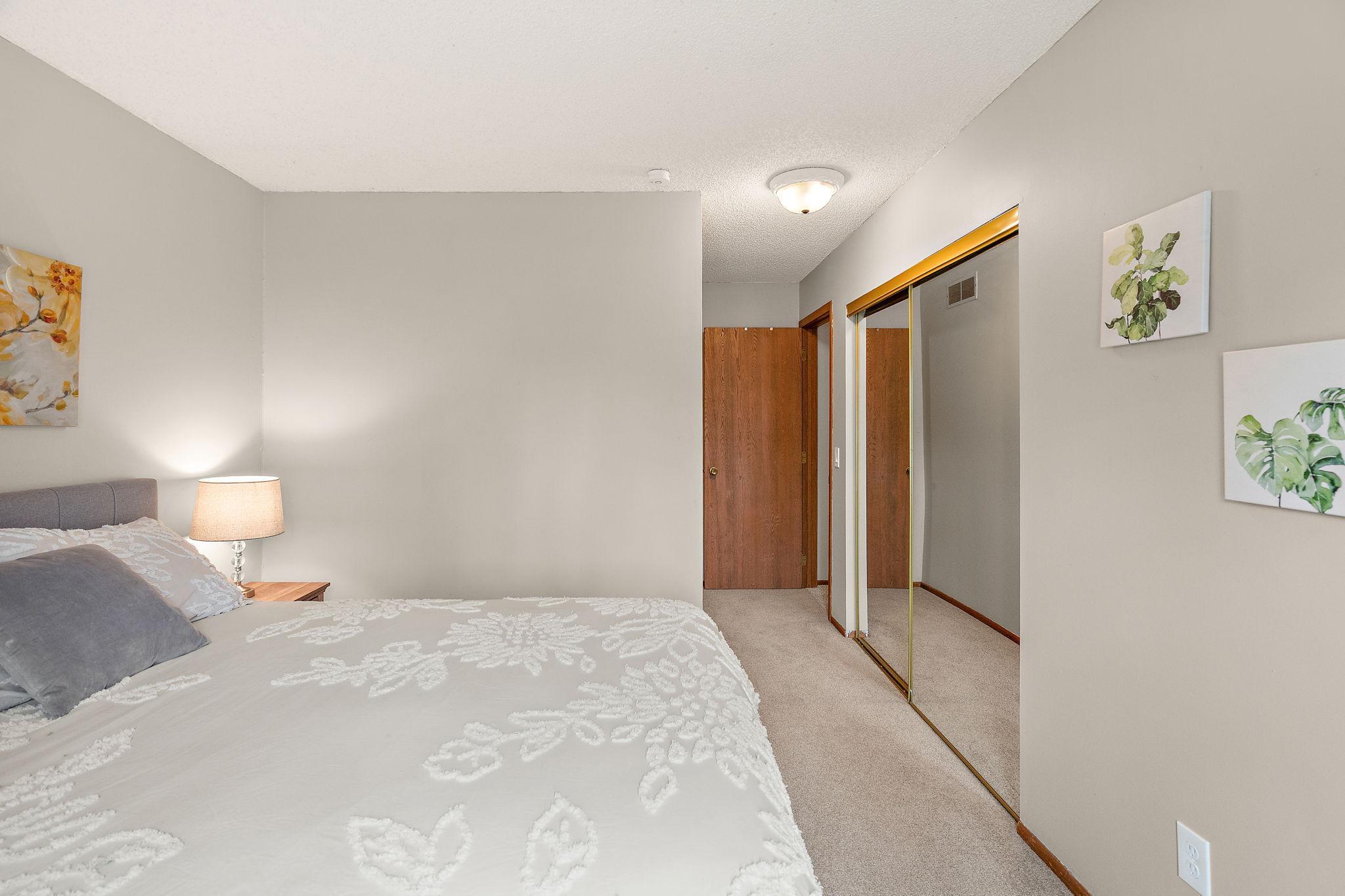 The upper level second bedroom has a nice large closet with mirror.