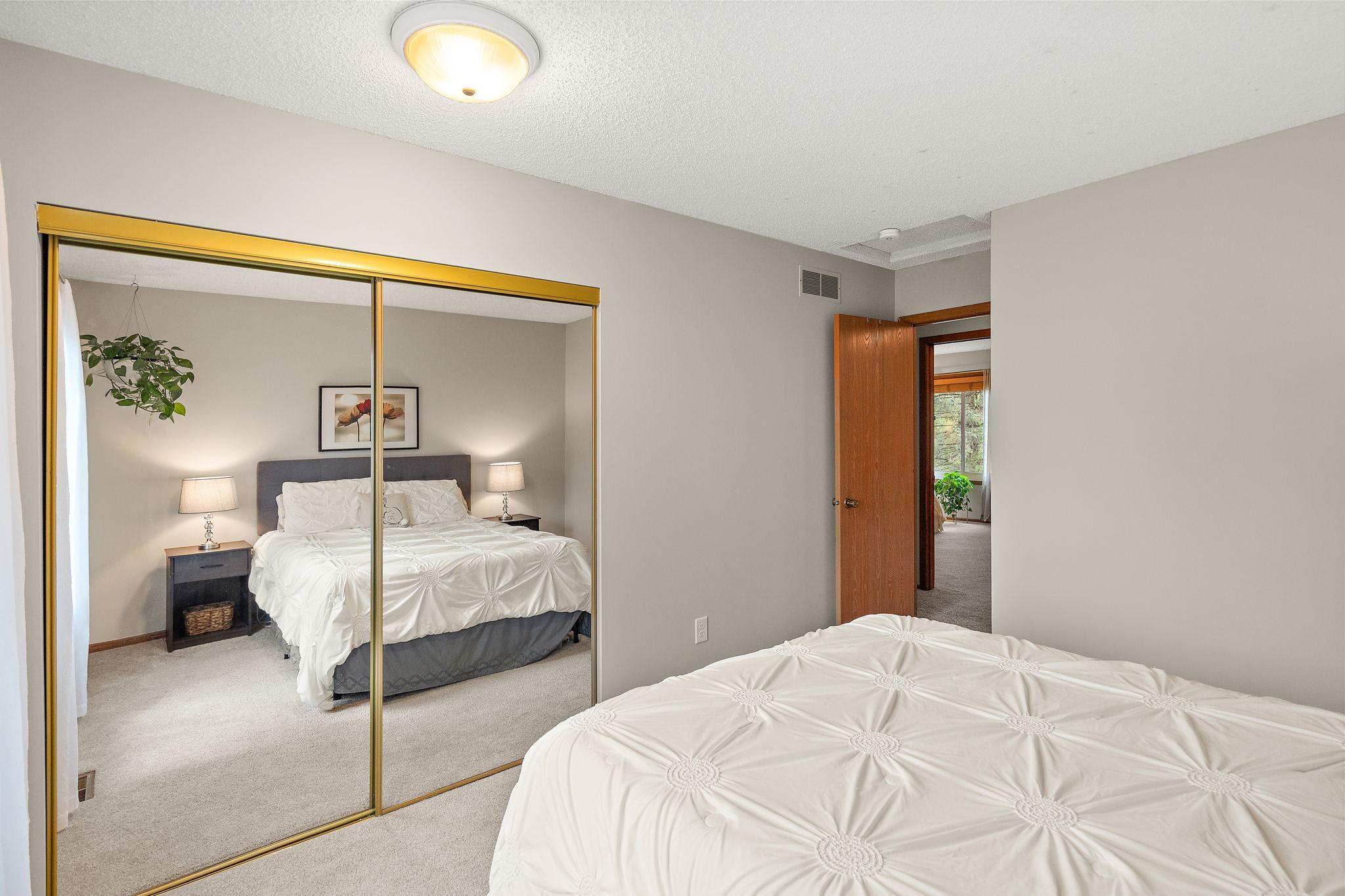 The upper level third bedroom closet has also has a full length mirror.